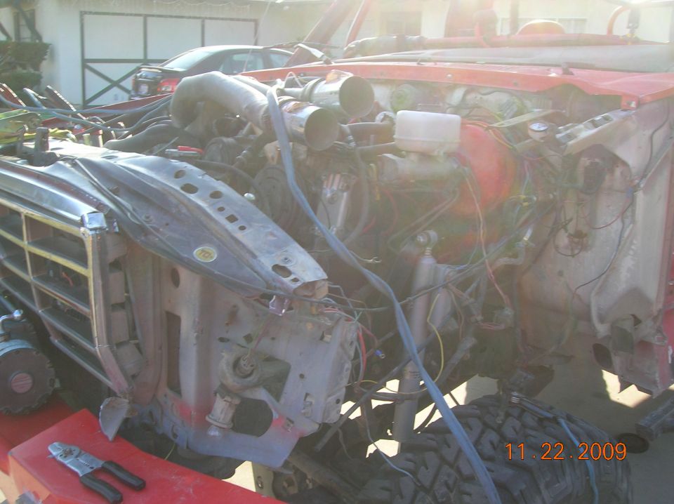 1985 Ford Bronco engine bay with exposed wiring and intake manifold