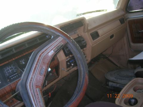 1985 Ford Bronco - The interior of a 1985 Ford Bronco shows its woodgrain trim and a cracked dashboard, with a date stamp of 11.22.2009.