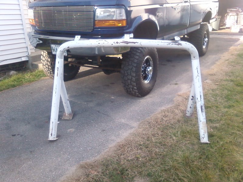 Front view of a 1997 Ford F-350 pickup truck with a white ladder rack in front of it