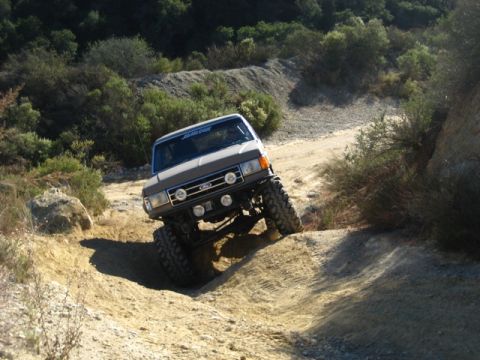 1989 Ford Bronco - This 1989 Ford Bronco tackles a challenging off-road trail, demonstrating its capabilities.