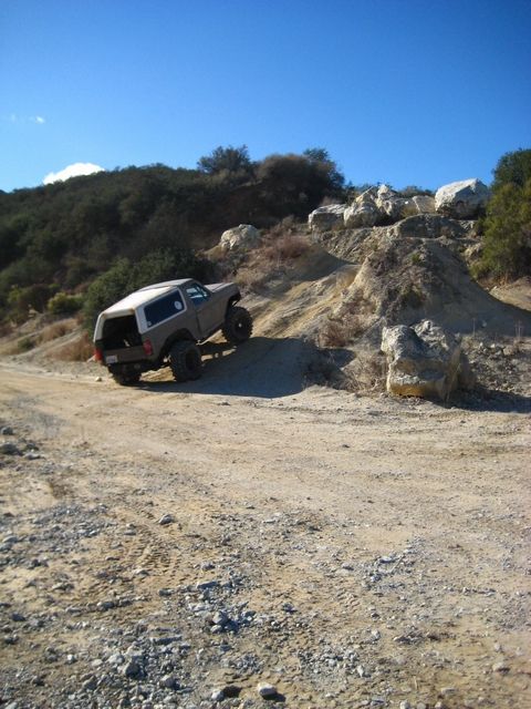 1989 Ford Bronco - Off-roading in a 1989 Ford Bronco on a challenging dirt trail.
