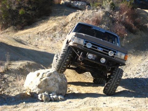 1989 Ford Bronco - This 1989 Ford Bronco is navigating a rocky trail, with one wheel elevated on a boulder.