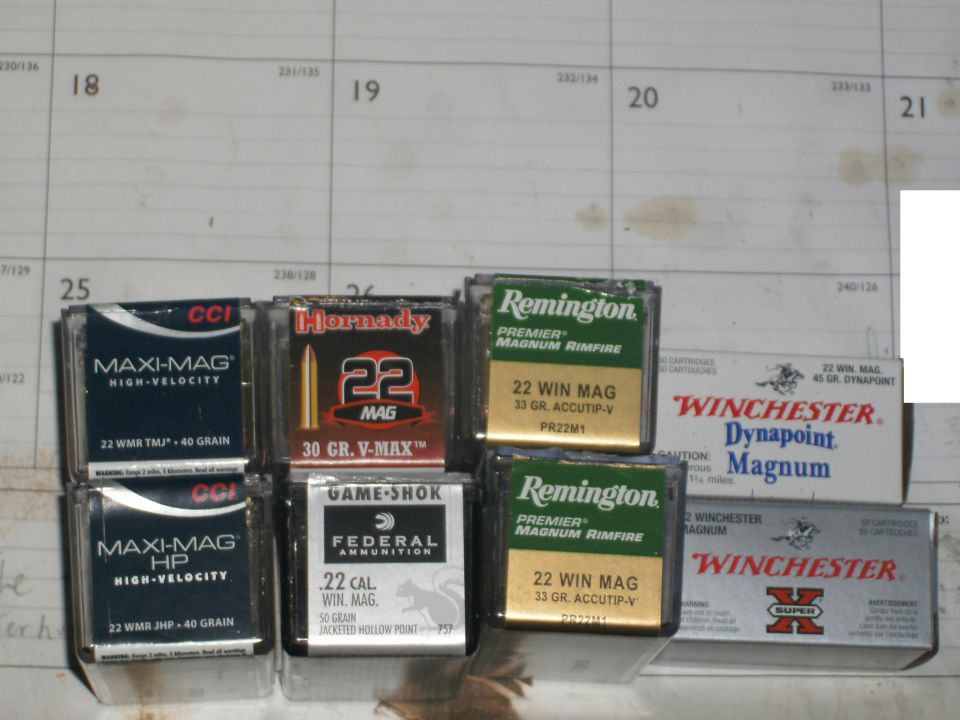 Six boxes of .22 magnum rimfire ammunition on a desk calendar