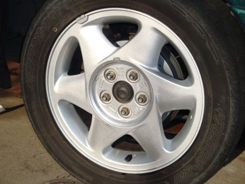 1995 Ford Taurus - Car wheel and tire detail, showing the Fuzion ZRi tire and silver alloy wheel.