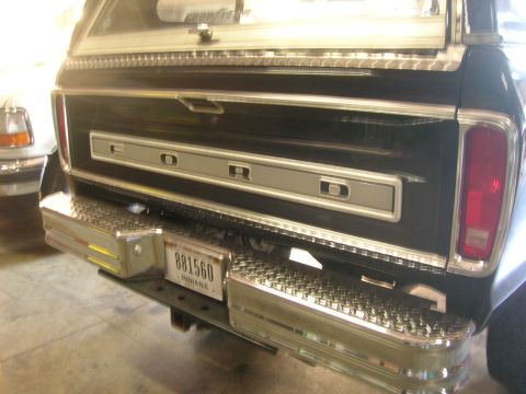 1975 Ford F-250 - This 1975 Ford F-250 pickup truck features a black exterior, chrome bumpers, and a distinctive rear tailgate with the Ford logo.