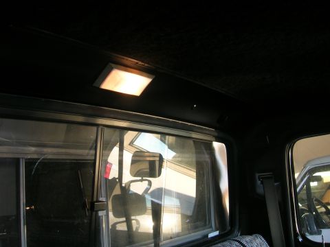 1975 Ford F-250 - Interior view of a truck cab, focusing on the headliner and dome light.