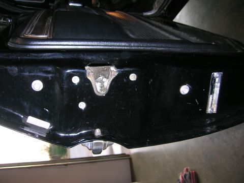 1975 Ford F-250 - Close-up view of a black door latch mechanism, showing bolts and a metal bracket.