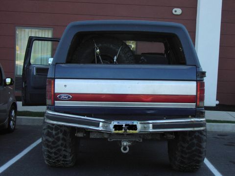 1986 Ford Bronco - This lifted Ford Bronco shows its rear end, a spare tire mounted inside and a custom bumper.