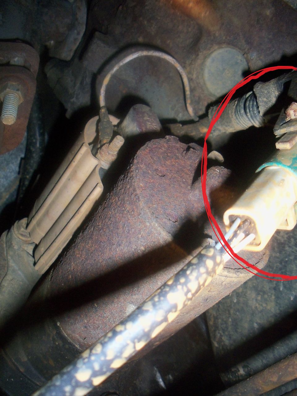 close-up of engine solenoid wiring with a red circle around a connector