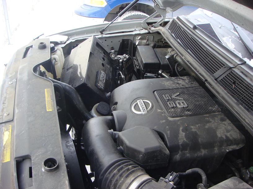 Engine bay of a 2008 Nissan Titan, showing the V8 engine cover with Nissan logo and 5.6L designation