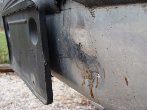 1993 Ford Bronco - Detail of a worn rear bumper showing signs of rust and damage.