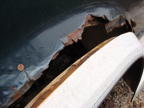 1993 Ford Bronco - Significant rust damage is visible on the wheel well of this vehicle.