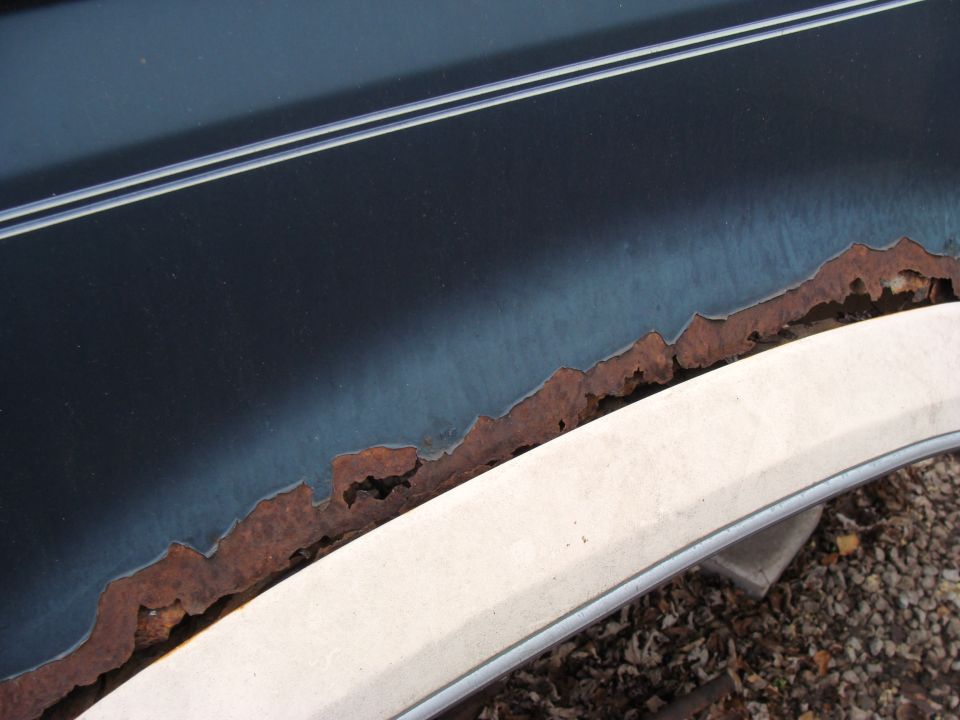 Close-up of rusted trim on a vehicle fender flare