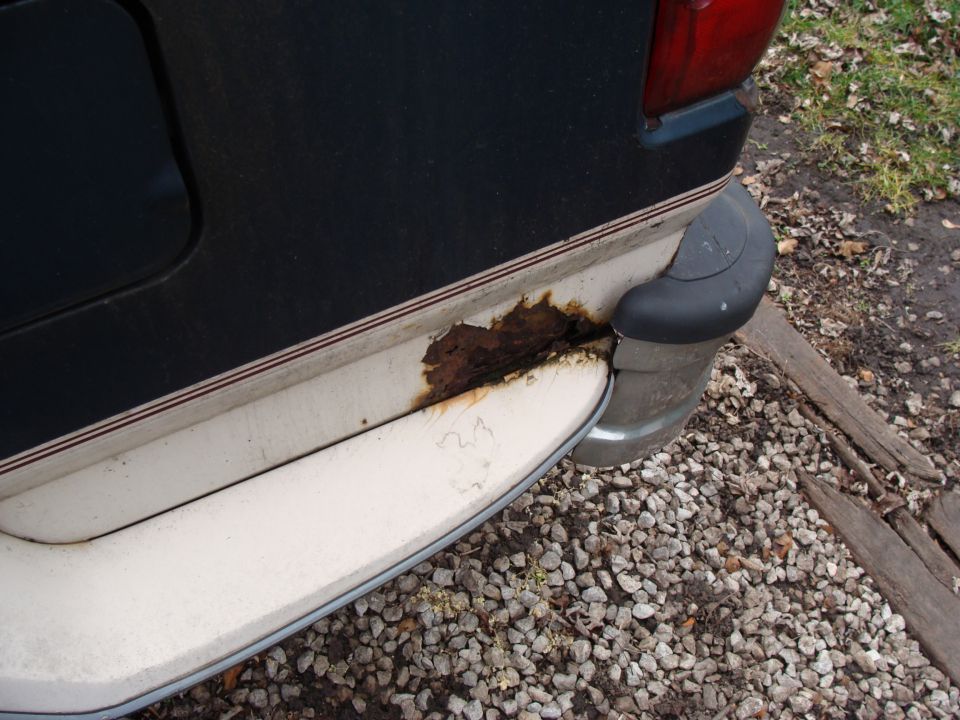 Rear bumper area of a vehicle with significant rust damage