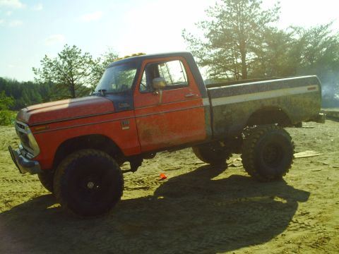 1990 Ford Bronco - This lifted pickup truck, likely from the 1970s, does not match the registry's claim of a 1990 Ford Bronco.