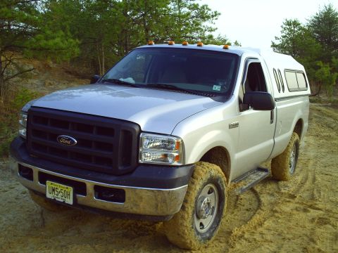 1990 Ford Bronco - This Ford F-250 Super Duty pickup truck is equipped with a camper shell and appears to be off-road.