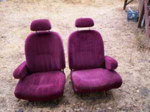 1991 Ford Bronco - Two front car seats are shown outdoors on a dirt and gravel surface.