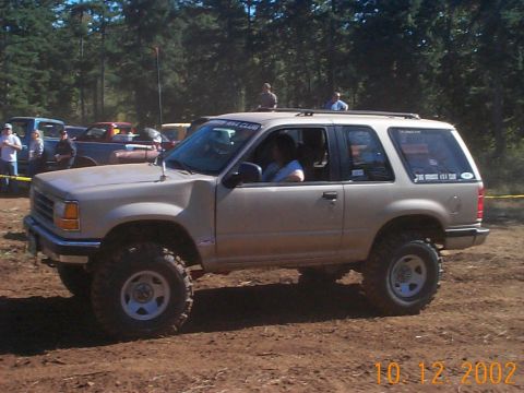 1994 Ford Explorer - This lifted 1994 Ford Explorer is ready for off-road action, with other vehicles and spectators present.