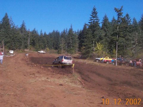 1994 Ford Explorer - Multiple vehicles compete in an off-road event on a sunny day.