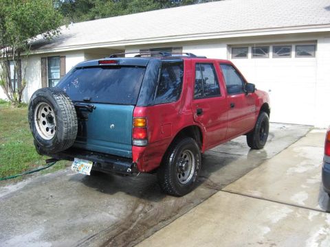1993 Isuzu Rodeo - This 1993 Isuzu Rodeo is seen from the rear, a two-tone paint scheme and a spare tire mounted externally.