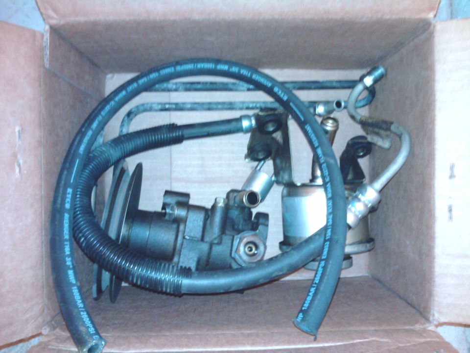 Power steering pump and hoses in a cardboard box