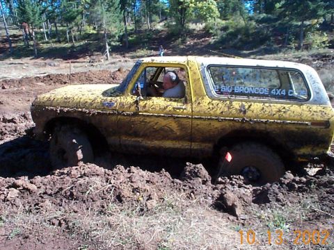 1994 Ford Explorer - Muddy 1978 Ford Bronco stuck during an off-road event. The vehicle is partially submerged in thick mud.