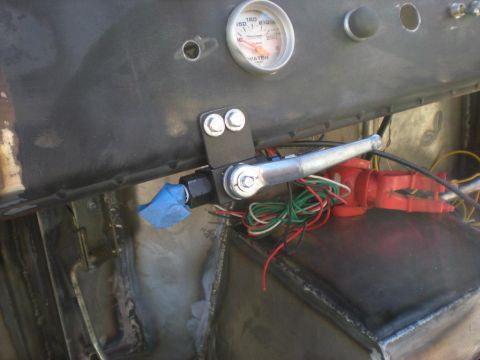 Suzuki Samurai - In-progress dash wiring on a bare-metal custom build: an Auto Meter water temperature gauge reading to 250 is installed in the sheet-metal…