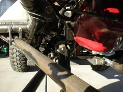 2009 Suzuki Samurai - Undercarriage view of a custom off-road vehicle's suspension and engine area.