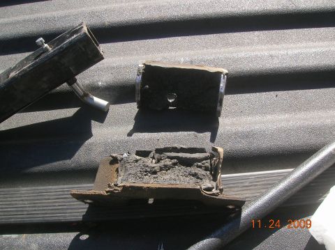 1985 Ford Bronco - Damaged vehicle mounts, likely engine or transmission mounts, are shown resting on a textured surface.