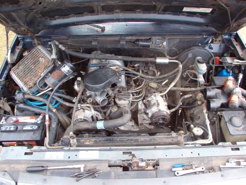 1993 Ford Bronco - The evaporator has been removed from its housing; the compressor is unbolted from the engine; & the condenser is loose, but still in place.…