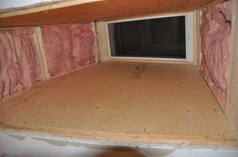 1996 Ford Bronco - This unfinished skylight tunnel shows exposed plywood flooring and pink insulation within the wooden frame.