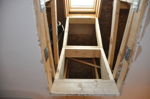 1996 Ford Bronco - Unfinished attic framing around a skylight tunnel, revealing construction materials and structural supports.