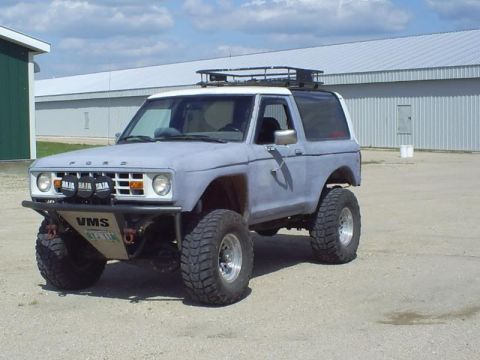 1991 Ford Bronco - This 1991 Ford Bronco features a lifted suspension, off-road tires, and a roof rack, suggesting it's modified for off-road use.