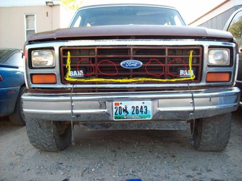 1985 Ford Bronco - Front view of a 1985 Ford Bronco's grille, Baja badging and the Ford logo.