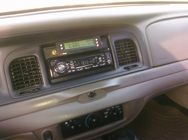 2002 Ford Crown Victoria interior showing dashboard, aftermarket stereo, and air vents