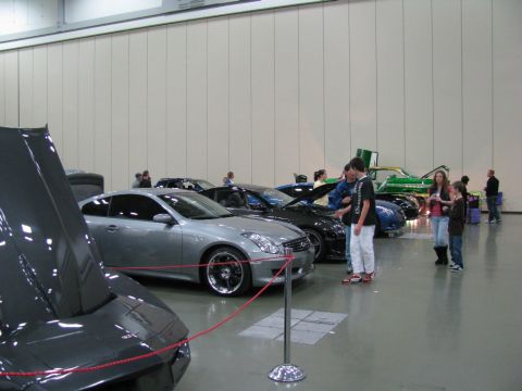 2003 Mercury Marauder - Cars are displayed at an indoor event with spectators observing the vehicles.