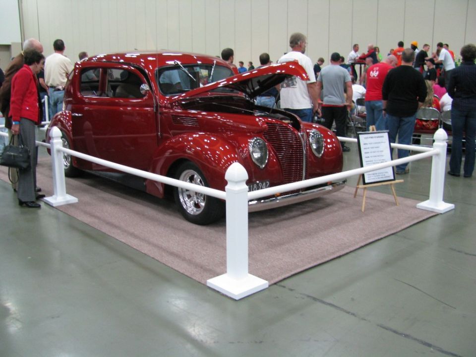Red 1939 sedan with hood open, chrome grille, and custom wheels