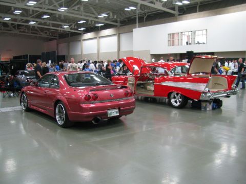 2003 Mercury Marauder - Two cars are displayed indoors with their hoods and doors open, attracting a crowd.