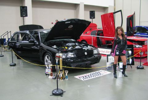 2003 Mercury Marauder - A black 2003 Mercury Marauder is displayed with its hood open, surrounded by trophies at a car show.