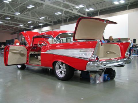 2003 Mercury Marauder - A classic red Chevrolet with its doors and trunk open, displayed indoors.