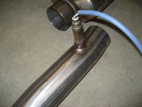 1996 Ford Bronco - Close-up of an exhaust pipe section with an attached oxygen sensor and a blue wire.