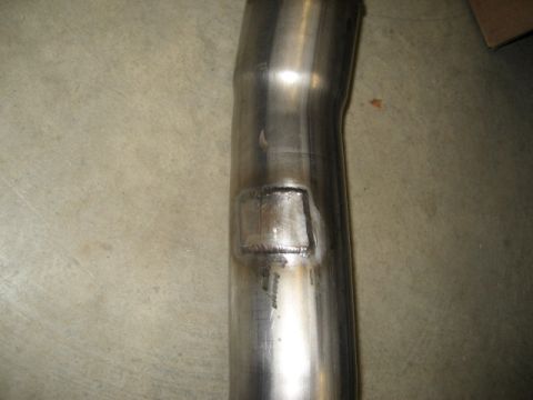 1996 Ford Bronco - Exhaust pipe section with a square weld repair patch visible.