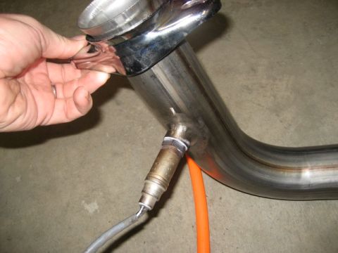 1996 Ford Bronco - Close-up of a vehicle exhaust pipe section with an oxygen sensor installed.