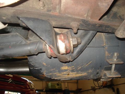 1986 Ford Bronco - Close-up view of a vehicle's underbody suspension component, showing bushings and metal brackets.