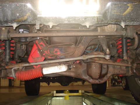 1986 Ford Bronco - Front suspension and steering linkage of a 1986 Ford Bronco viewed from below.