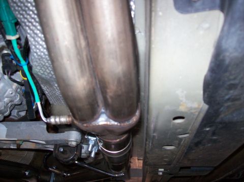 2007 Ford Mustang - Close-up view of exhaust headers and wiring, likely from a performance upgrade.