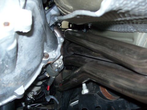 2007 Ford Mustang - Underside view of a vehicle's engine bay, focusing on the exhaust system and associated components.