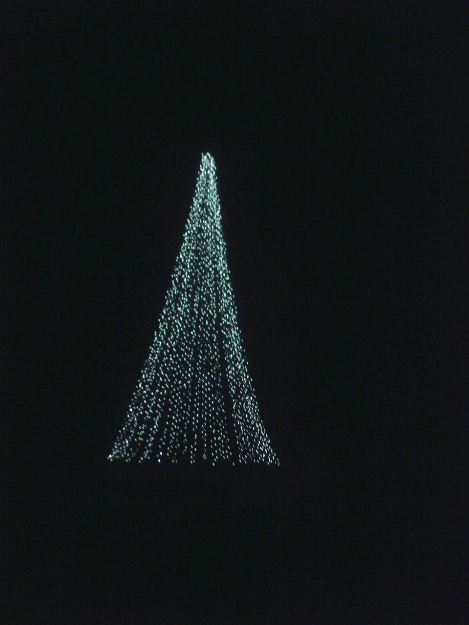 Illuminated triangular cone of lights on a black background