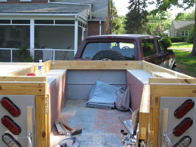 1996 Ford Bronco rear interior with spare tire visible, viewed from trailer bed