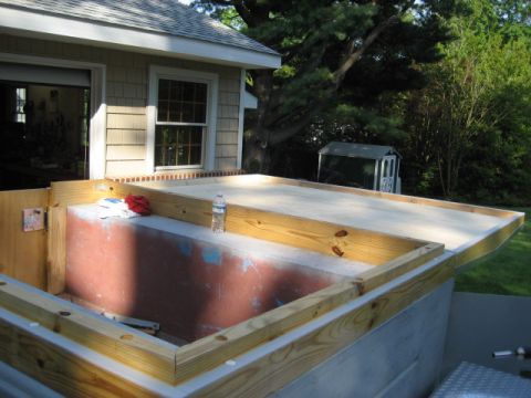1996 Ford Bronco - Construction is underway for a basement window well, with framing and concrete visible.
